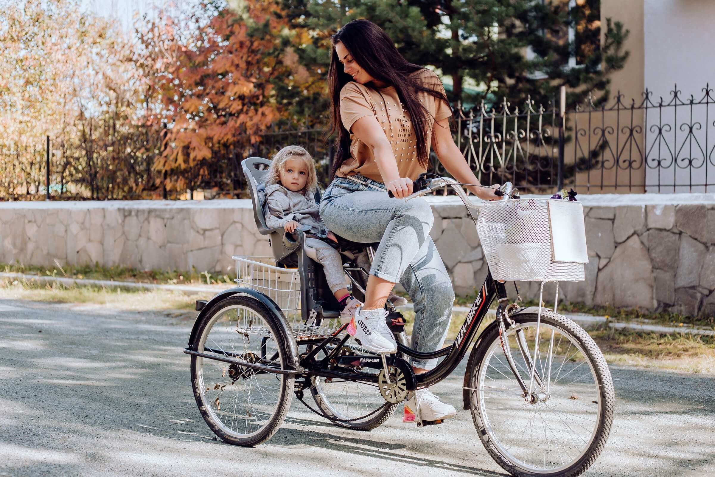 Девушка на велосипеде с ребенком